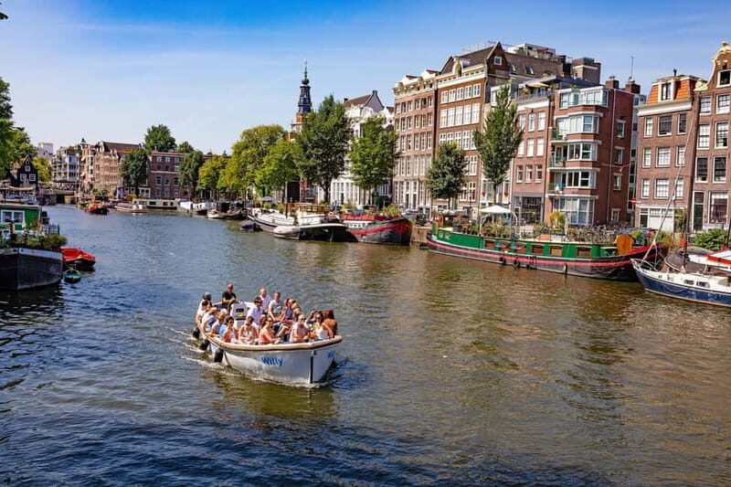 Amsterdam: 75 minute Open Boat Canal Cruise with Live Guide - The open-boat advantage: better angles, smaller canals, easier photos