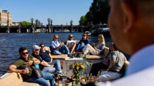 Amsterdam: Canal Cruise in Open Boat with Drink Option - On the water in an open boat with an electric engine