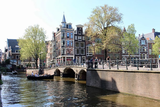 Amsterdam Canal Tour by Open Boat – 90 min Small Group Experience - Spot the leaning houses along the Amstel River