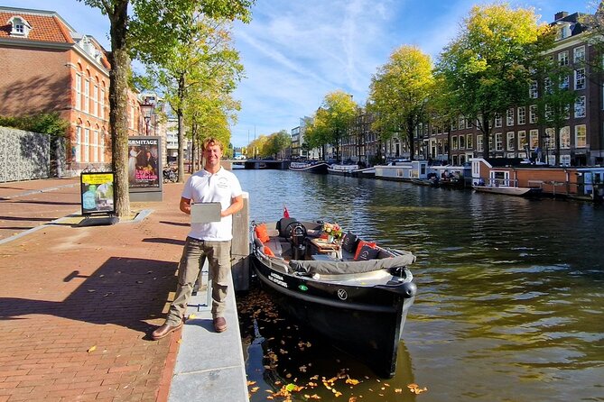 Amsterdam Canal Tour by Open Boat – 90 min Small Group Experience - Munt Tower and the tight canal moments you can’t fake