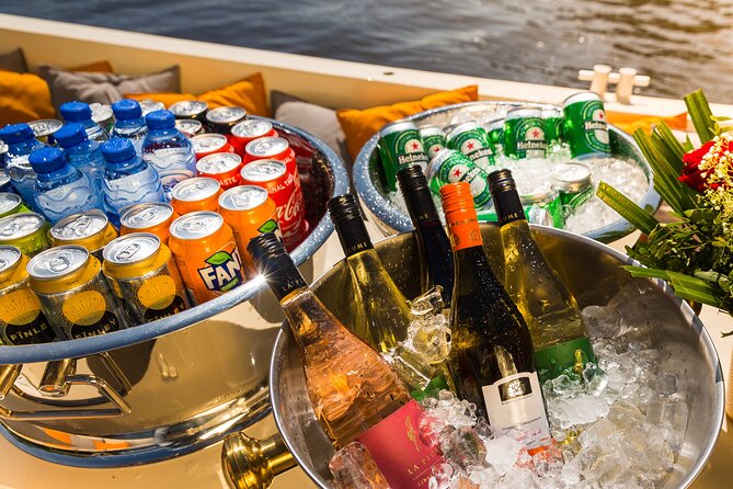 Amsterdam Classic Saloon Boat Canal Cruise with Live Guide - Amstel River Cruise: Seeing Amsterdam’s Lifeline