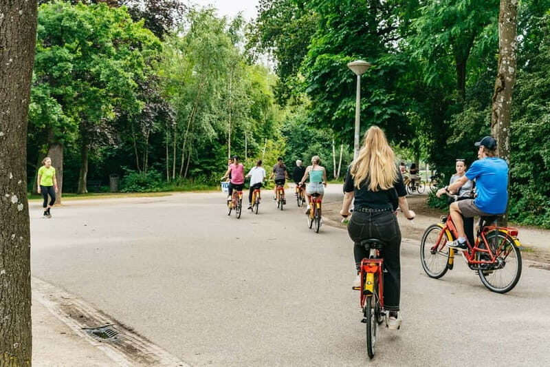 Amsterdam: Guided Bike Tour City Centre in EN/DE/FR/ES - Leidseplein square: street performers, theater energy, and a quick reality check