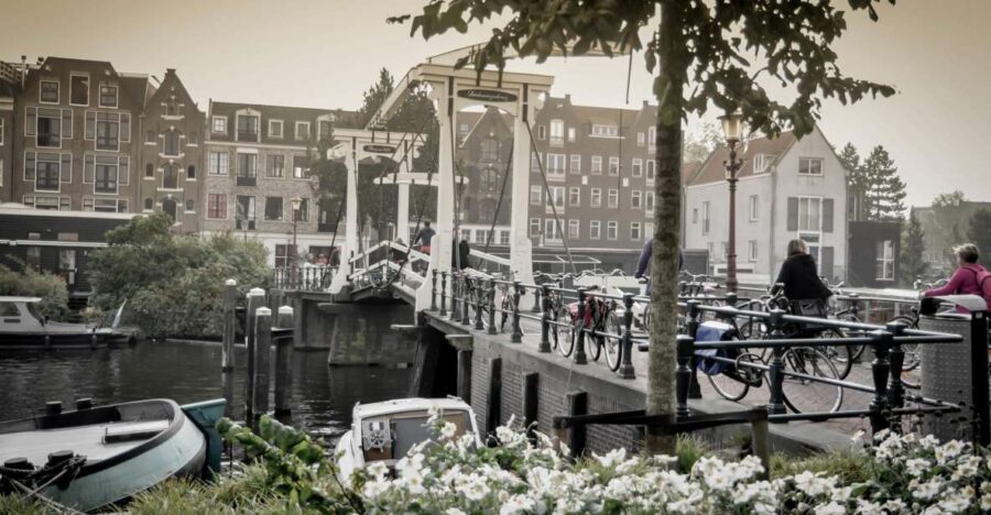 Amsterdam: Guided City Bike Tour in French - Getting in motion at IJdok 47: meeting point, shoes, and bike basics