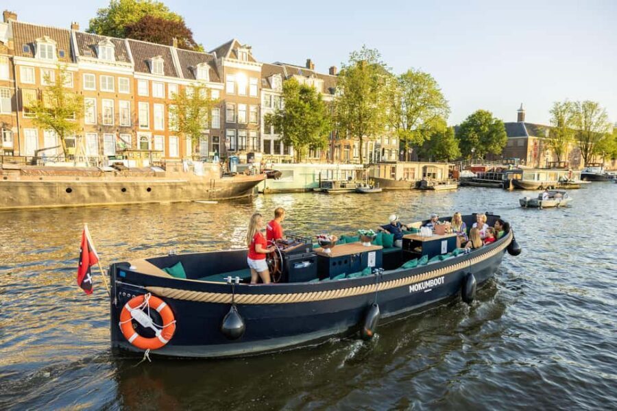 Amsterdam: Guided Open Boat Canal Cruise Including Drink - What the ride feels like: breeze, comfort gear, and a relaxed pace
