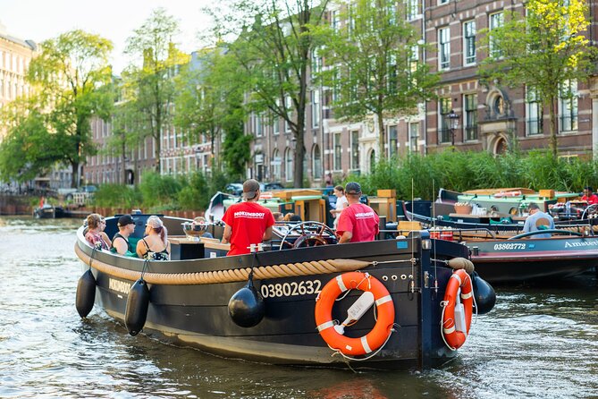Amsterdam: Guided Open Boat Canal Cruise Unlimited Drinks Option - Jewish history, Rembrandt’s world, theaters, and the canal-belt icons