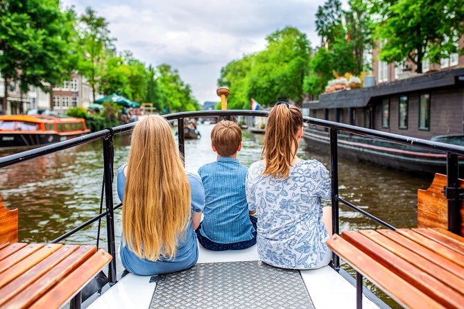 Amsterdam Small-Group Canal Cruise With Dutch Snacks and Drink - Amstel River, bridges, and the city moving around you