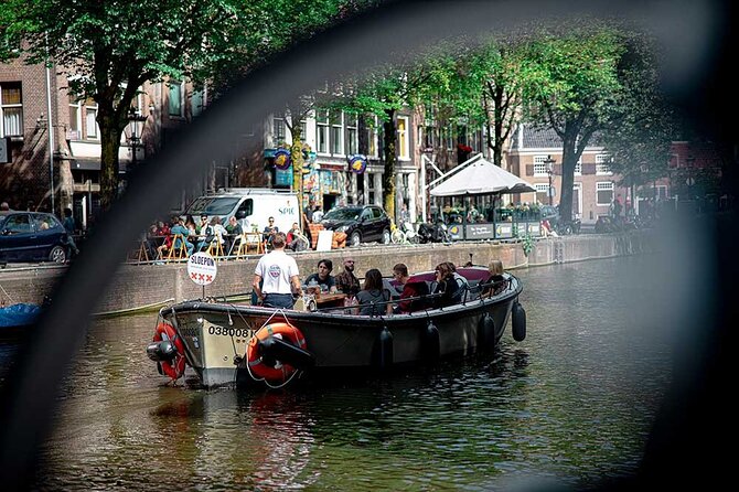 Guided Amsterdam Canal Cruise – Snacks & Drinks on board(1 Hour) - The oldest streets, leaning houses, and a Red Light District church with 1306 roots